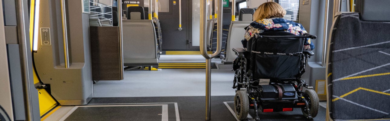 A passenger using a wheelchair is travelling on board a 777 train.  