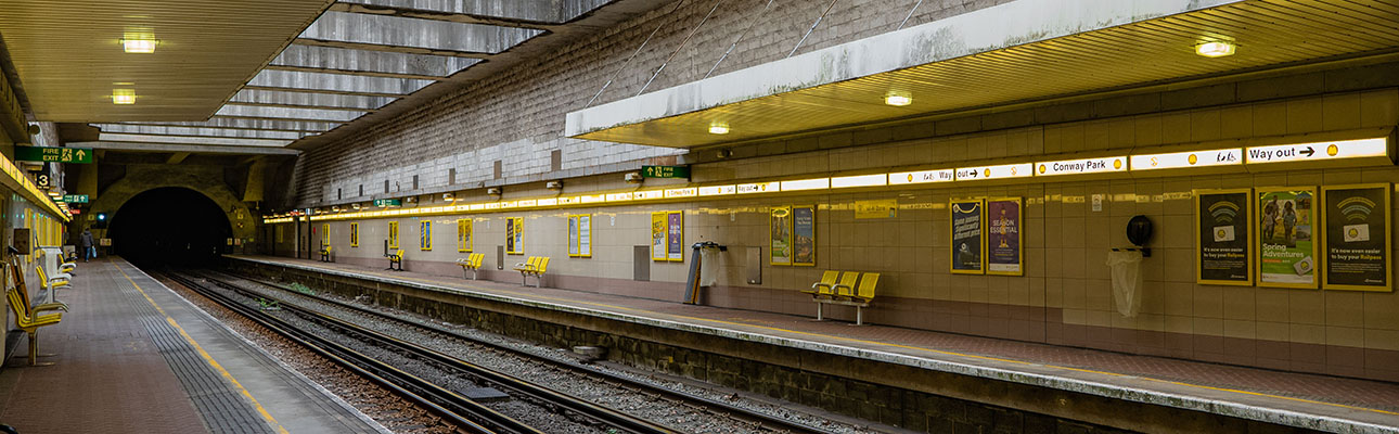 The underground station platform at Conway Park station in Birkenhead. Shelter and seating appear. 