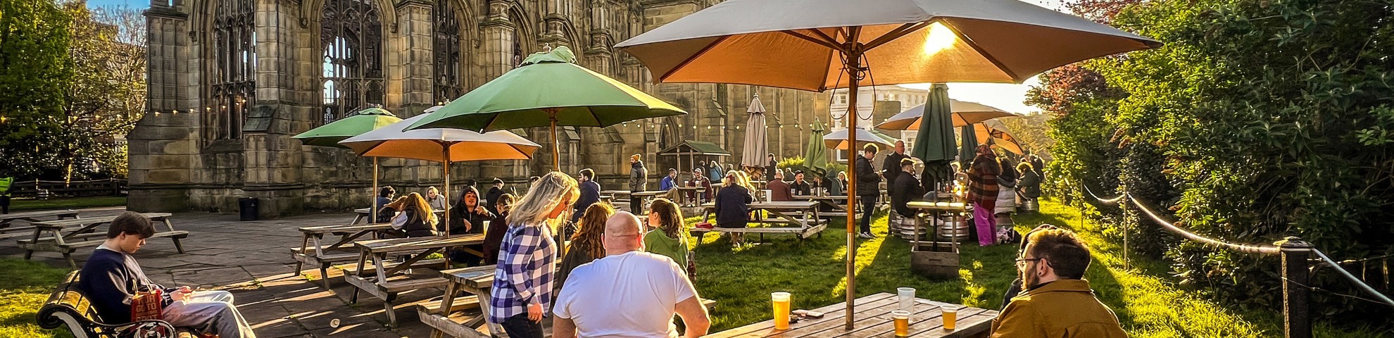 Outdoor dining on a sunny day with the bombed out church in the background.