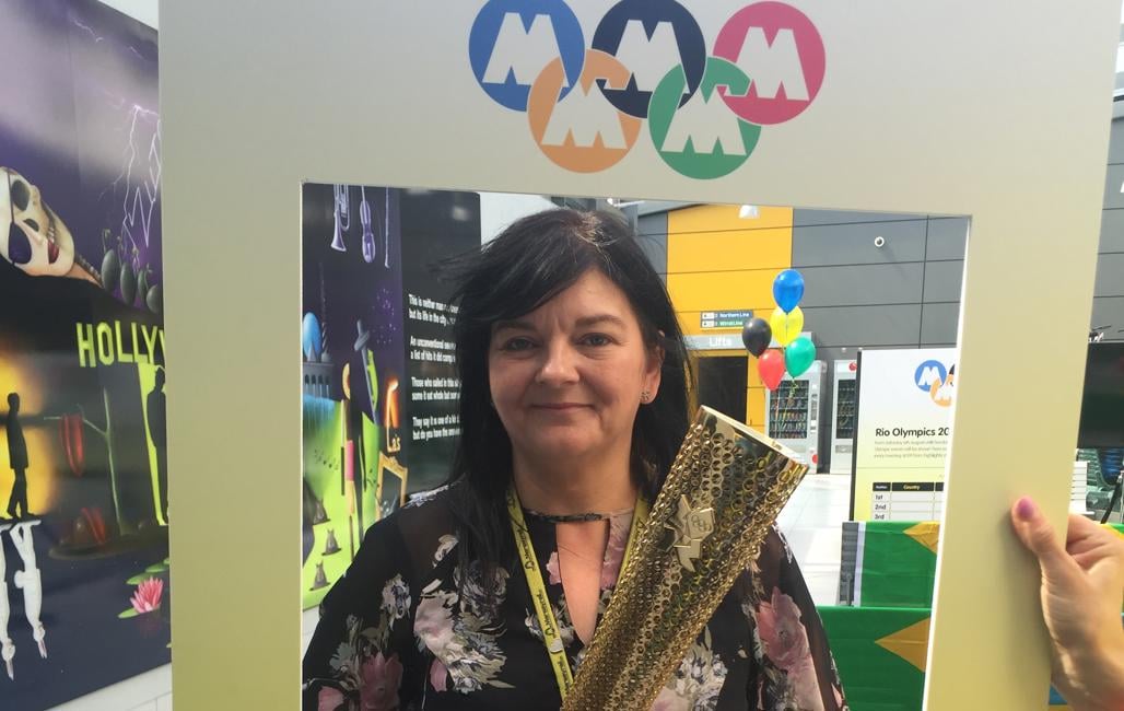A member of Merseyrail staff with the Olympic Torch. 
