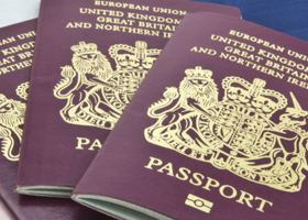 Three passports laid on top of one another. 