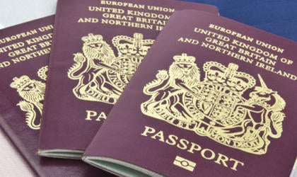 Three passports laid on top of one another. 