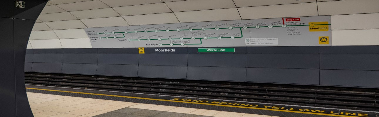 A banner at an underground station displaying information about the Wirral line. 