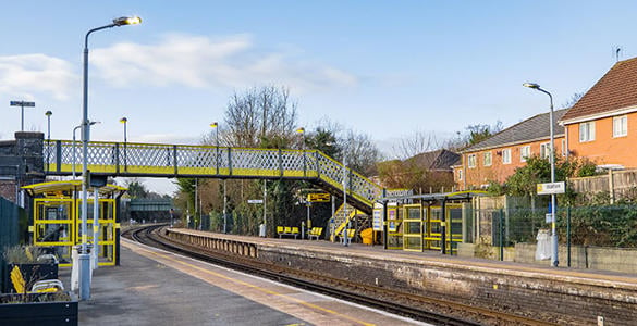 The platform at Walton station. A pedestrian footbridge appears in the distance. 