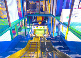 Colourful soft play area with a slides.