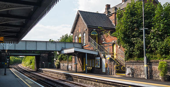 A pedestrian foot bridge above the platform and railway tracks at Aigburth station. 
