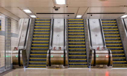 Three escalators at a station. 