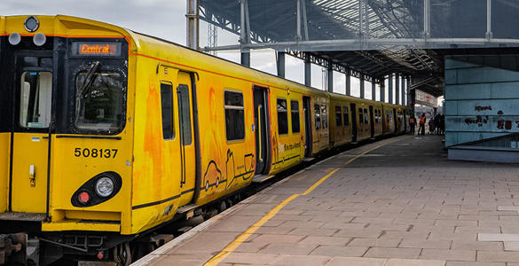 A Merseyrail train stopped at Chester station platform. 