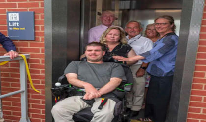 Members of the community stood in a lift at Birkenhead Park station. 