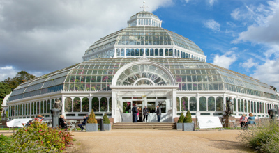 Glass building called the Palm House on a summer's day