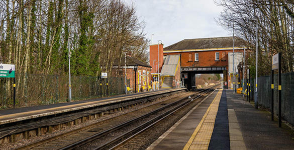 The platform at Hillside station. The station ticket office is located above a tunnel bridge in the distance. 