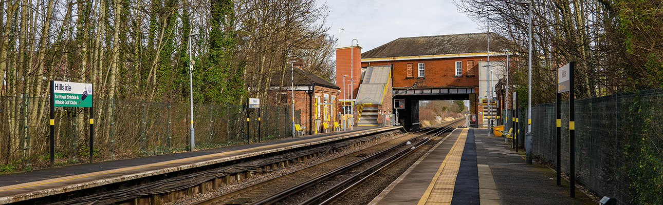 The platform at Hillside station. The station ticket office is located above a tunnel bridge in the distance. 