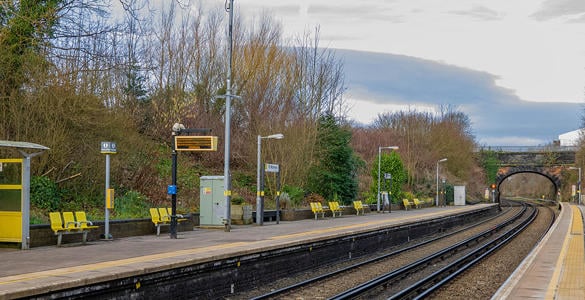 The platform at St Michaels station. Seating and digital signage appears along the platform. Trees and a tunnel bridge appear in the distance. 
