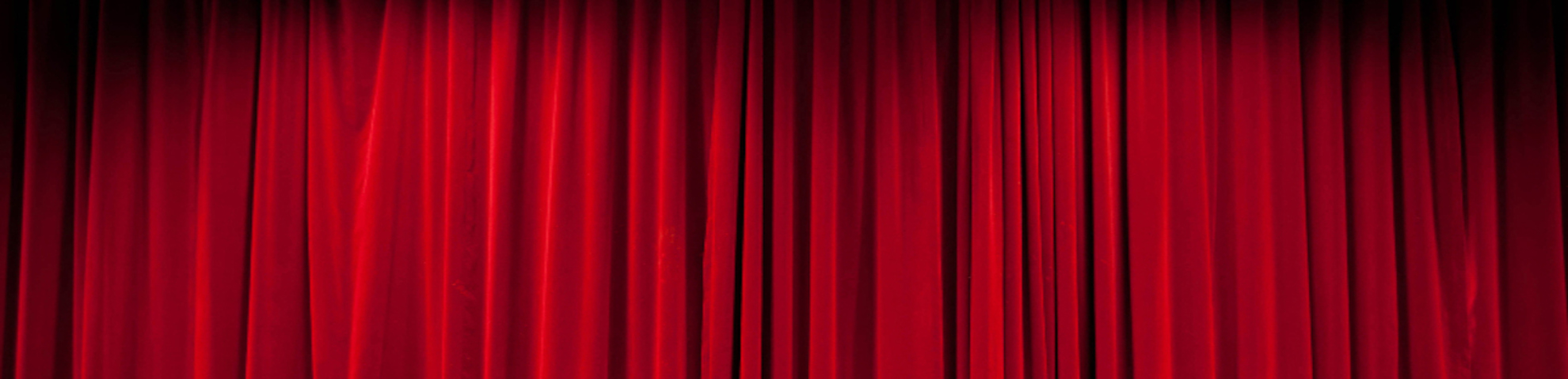 Red curtain on a theatre stage.