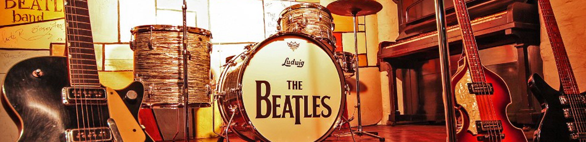 Band instruments on stage. The drum kit has 'The Beatles' written on it.