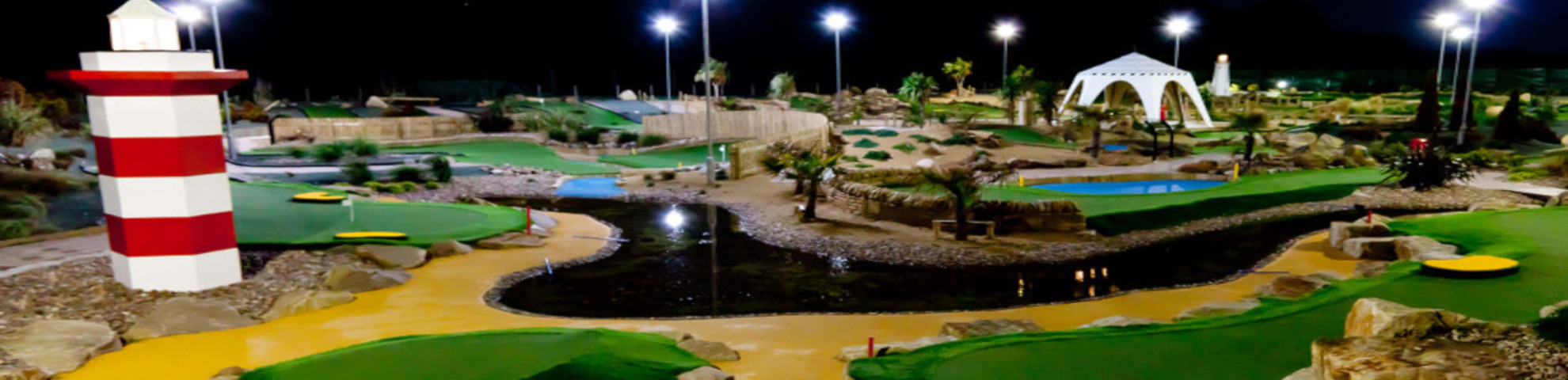 An outdoor children's golf course at night time.