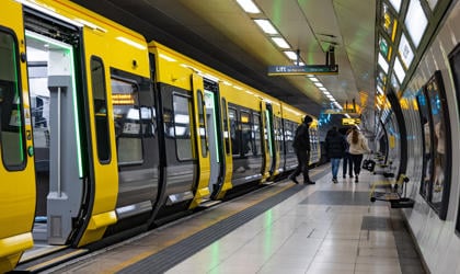 A 777 train at an underground station platform. 